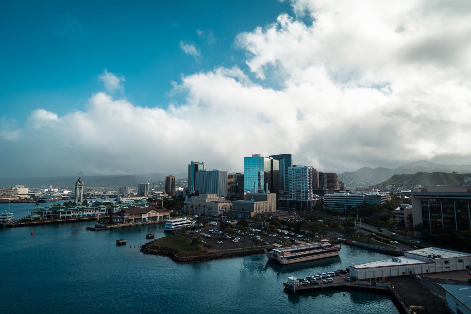 Honolulu cruise port: piers and harbor buildings below the downtown towers on Honolulu Harbor